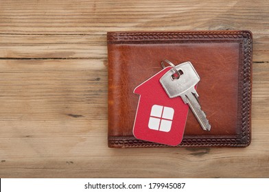 wallet and key on wood background 