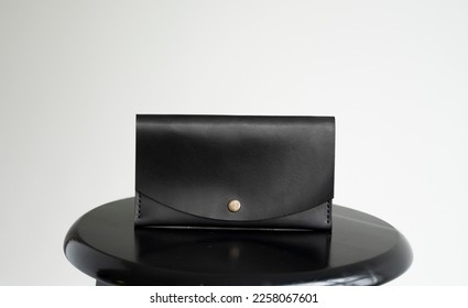 Wallet made of genuine black leather with a slots for cards and big zip pocket on a white background. Accessories for men. - Shutterstock ID 2258067601