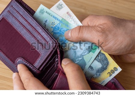 wallet with money, banknotes of 1 and 200 romanian lei, financial and economic concept, situation of households, inflation and price increase in romania
