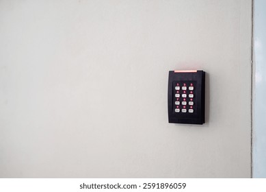 A wall-mounted access control system featuring a keypad designed for secure entry. Ideal for enhancing safety in various environments such as offices or homes.