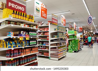 WALLONIA, BELGIUM - JULY 24, 2019: Interior of a Carrefour megastore. Aisles with shopping racks of a Carrefour Hypermarket.  