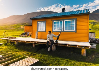 Wallpaper Norway Landscape Nature Of The Mountains Of Spitsbergen Longyearbyen Svalbard Building  On A Polar Day With Arctic Summer In The Sunset And Blue Sky With Clouds Hunter With A Gun