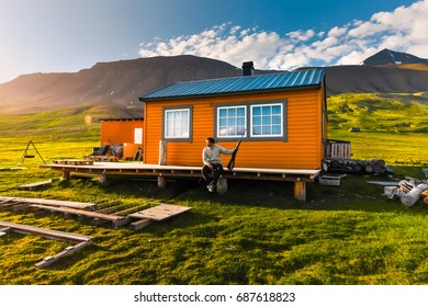 Wallpaper Norway Landscape Nature Of The Mountains Of Spitsbergen Longyearbyen Svalbard Building  On A Polar Day With Arctic Summer In The Sunset And Blue Sky With Clouds Hunter With A Gun