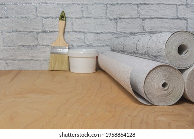 Wallpaper Rolls, Paintbrush And Glue Are Ready For The Room Renovation. DIY Repair.