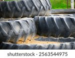 Wallpaper shot of large tractor tires stacked on top of each other at a local cider mill (apple orchard). Perfect background for the fall season and its festivities. Rural feel.