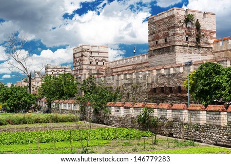 Walls of Constantinople view, Istanbul, Turkey. Old fortress wall is famous landmark of Istanbul, former Constantinople. Scenery of historic Byzantine monument, ancient ruins in Istanbul city center.