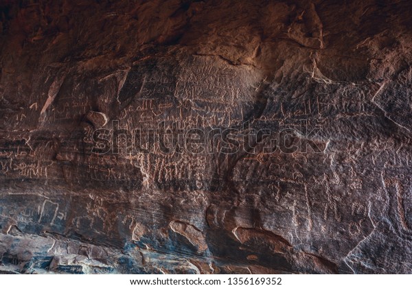 Walls covered with\
ancients drawings in Khazali gorge in famous Wadi Rum - Valley of\
Sand in southern Jordan