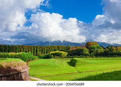 The Walls of Lucca public park near St Croce Bulwark with Apennine Mountains wrapped in clouds  - Shutterstock ID 2056956689