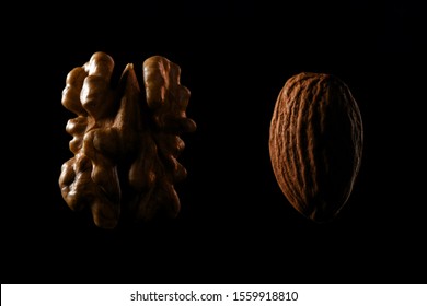 Walnut and almond macro shots of nuts on black background.