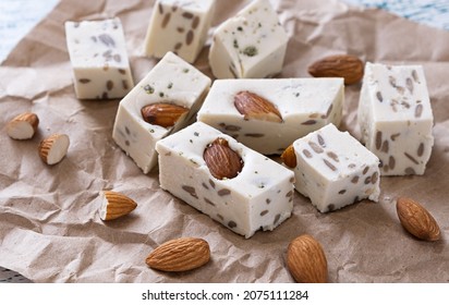 Walnut Halva With Almonds And Sunflower Seeds On Brown Craft Paper. Traditional Oriental Dessert.