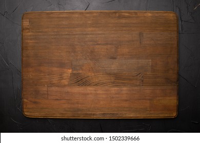 Walnut handmade wood cutting board on black wooden board - Shutterstock ID 1502339666