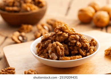 Walnut kernel and whole walnuts on a plate.Healthy Fats,Support weight management. - Powered by Shutterstock