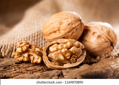Walnut kernels on rustic old oak table.