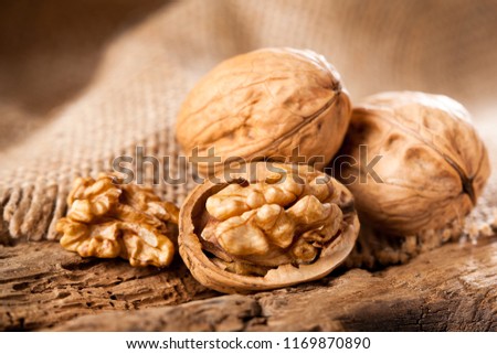 Walnut kernels on rustic old oak table.