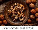 Walnut kernels and whole walnuts on a table.
Image of organic walnuts.