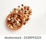 Walnut, macadamia nut, cashew nut, pecan on the plate and isolated on white background. Pile of mixed nuts on the light background.