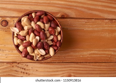walnut peanut in clay bowl. peanuts for food textures. peanut harvest. fried peanuts. texture of the nuts. photo for layout. Copyspace