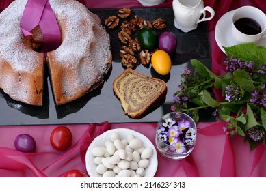 Walnut Roll: Bread Texture Of Sliced Potica, Sweet Bread Roll Stuffed With Walnuts.  Easter Cake Slices With Remaining Easter Bread Cake, Easter Eggs, Chocolate Coated Almonds, Flowers In Background.