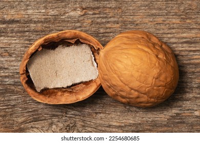 Walnut shell with a blank piece of paper. Copy space for your own message. New idea concept. - Shutterstock ID 2254680685
