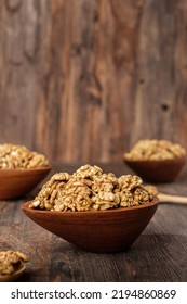 Walnut In Wood Bowl On Kitchen Table