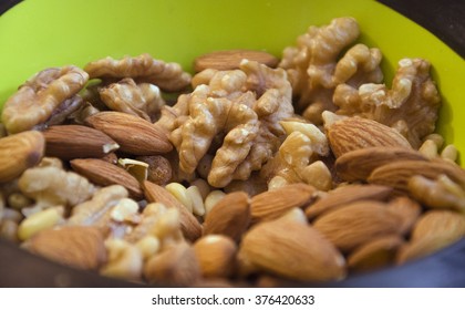 Walnuts And Almonds In A Green Vase