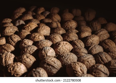 Walnuts Background. Tasty Nut Is Diet Snack. Close-up. Copy Space. Healthy Food. Drying Harvest. Useful Brain Nutrients. Brown Color. Wallpaper. Banner. Beautiful Still Life On Dark Backdrop. Texture.