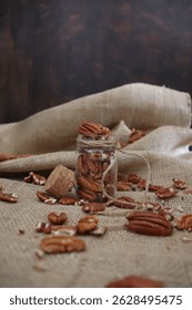 walnuts inside cute glass container on sackcloth background, hea