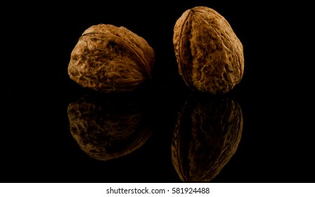 walnuts isolated on black reflective background
