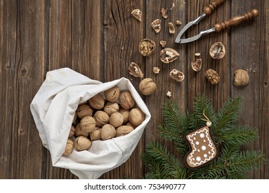 Walnuts, Nutcracker And Christmas Decor With Wooden Background. Top View, Close-up