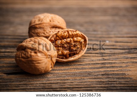 Walnuts on old wooden background