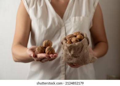 Walnuts In Shell In A Hand Of Woman 