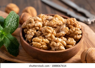 Walnuts in a wooden bowl, closeup view. Rich in protein and vitamins healthy shelled walnuts, vegan vegetarian snack  - Powered by Shutterstock