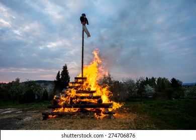 walpurgis night burning witch on wood and religion cross with huge flames