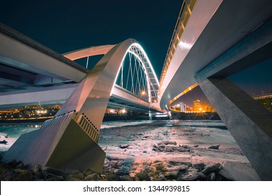 Walterdale Bridge, Edmonton Alberta, at night. Spanning the frozen river. - Shutterstock ID 1344939815