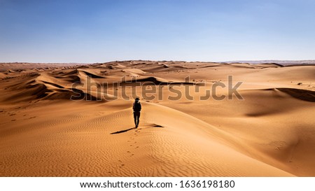 Wanderer in the desert.

A lonely explorer in the Sharqiya Sands Desert (Wahiba Sands), Oman. 