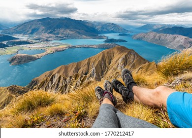 Wanderlust adventure and hiking travel vacation concept with hikers hiking boots close up. Hiker couple tramping up famous hike to Roys Peak on South Island, New Zealand. Couple resting and relaxing. - Shutterstock ID 1770212417