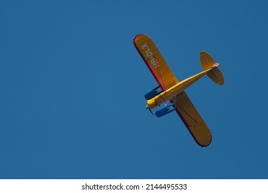 Wangen-Lachen, Switzerland, March 27, 2022 Piper PA18-180M Super Cub Propeller Plane In The Blue Sky