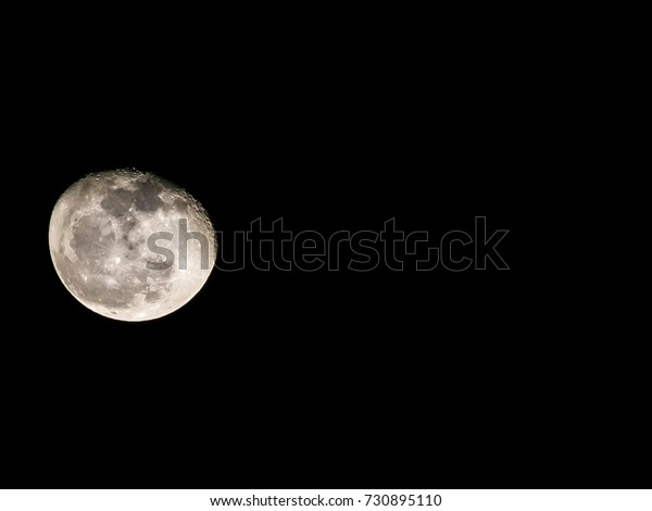 Waning\
Gibbous Moon with Moonlight closeup.\
The Moon in Waning Gibbous\
phase which almost full moon on night\
background.