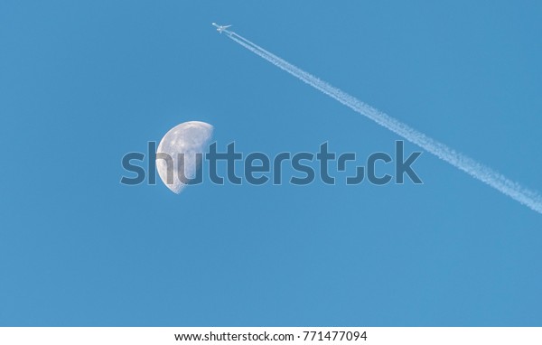 Waning Gibbous Moon near last quarter, daytime\
shot with an aeroplane over the\
moon.