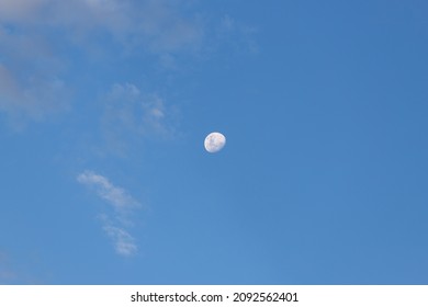 Waning gibbous moon on blue sky.