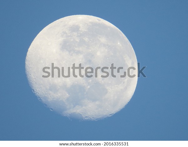 waning moon with blue\
background