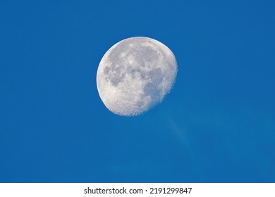 Waning Moon On Day On A Blue Clear Sky