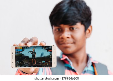 Wankaner, India - Circa 2020: Portrait Of An Indian Kid Showing PUBG Mobile Game On His Phone