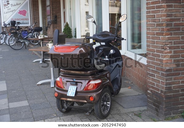 Wankum,Germany-September 21: Three wheels scooter\
for old people parked in front of a\
shop.