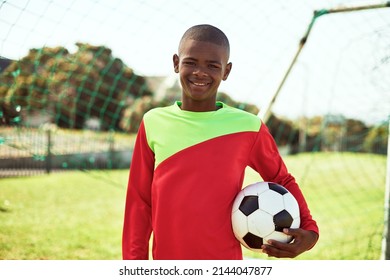 Wanna play some footy. Portrait of a young boy playing soccer on a sports field. - Powered by Shutterstock