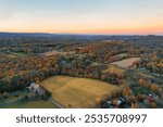 Wantage NJ farmlands at dusk in Autumn with High Point State Park Monument on Kittatinny Mountains aerial