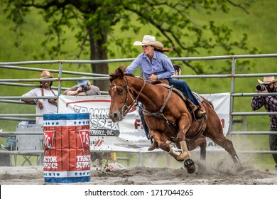 Wantage, NJ USA May 25,2019 Female Barrel Racer Making the Turn Around the Barrel at Green Valley Farms