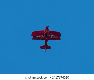 Wantagh, New York, USA - 24 May 2019: The Oracle d bi-plane perfoming on the Friday practice day of Memorial Day weekend at Jones Beach, NY. hanging tail down in the sky.