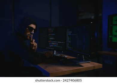 Wanted hackers coding virus ransomware using laptops and computers. Cyber attack, system breaking and malware concept.