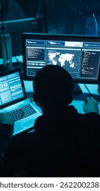 Wanted hackers coding virus ransomware using laptops and computers. Cyber attack, system breaking and malware concept.